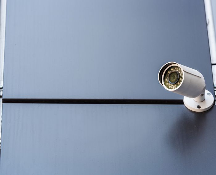 security camera on wall of office building, security system concept